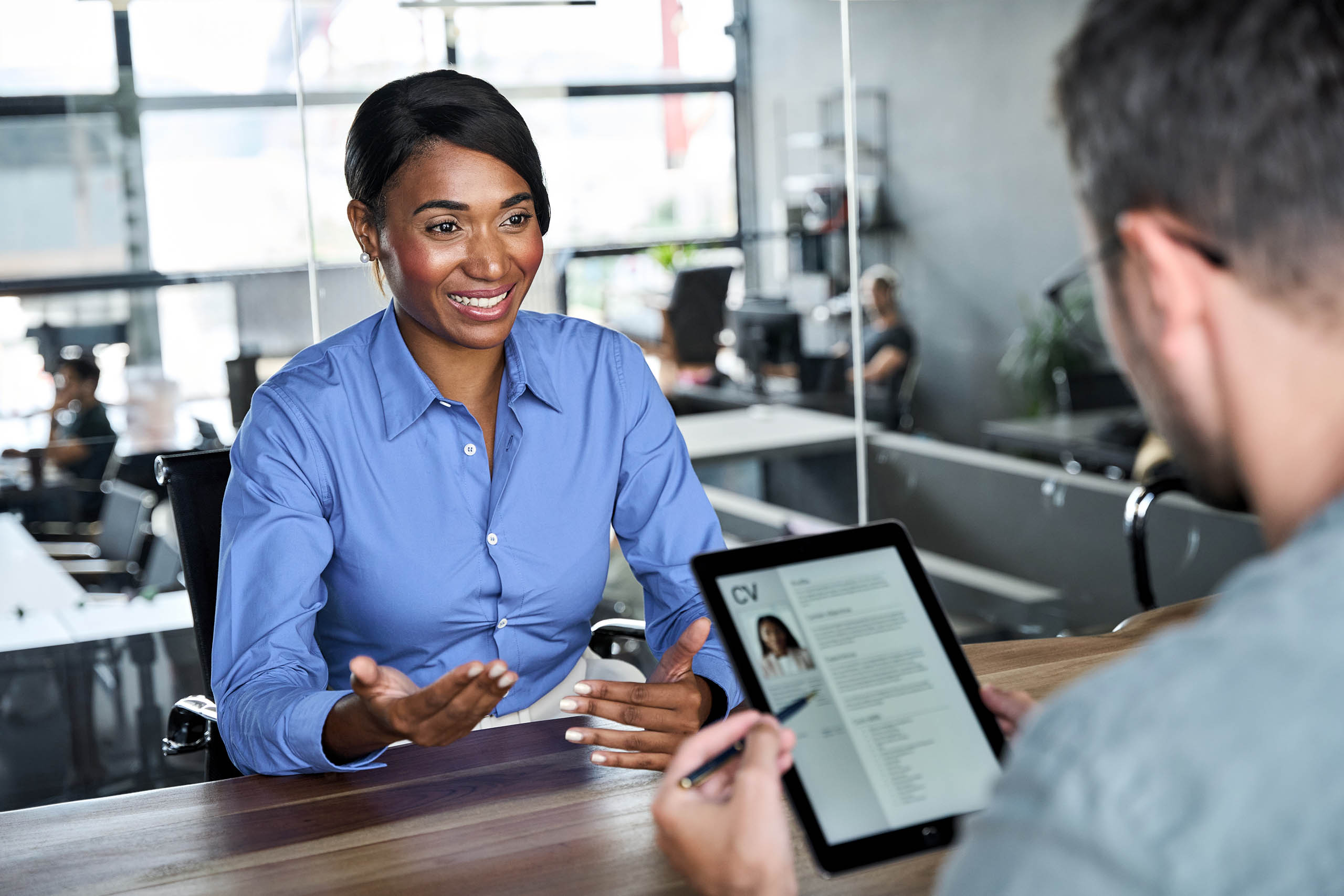 African American woman job seeker talking to HR manager at interview meeting.